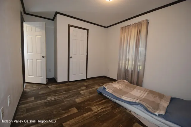 a view of a room with wooden floor