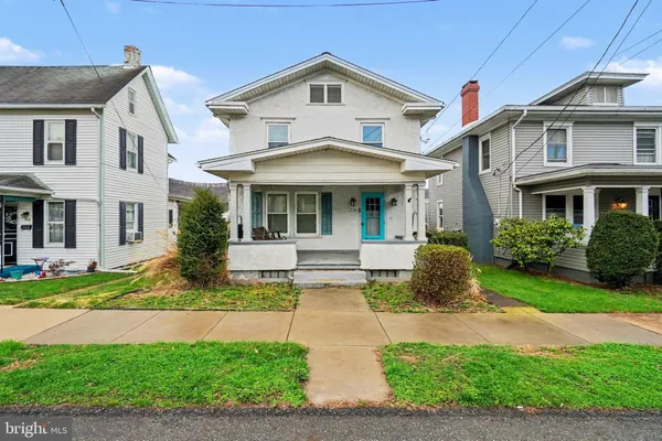a front view of a house with a yard and porch