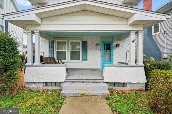 front view of a house with potted plants