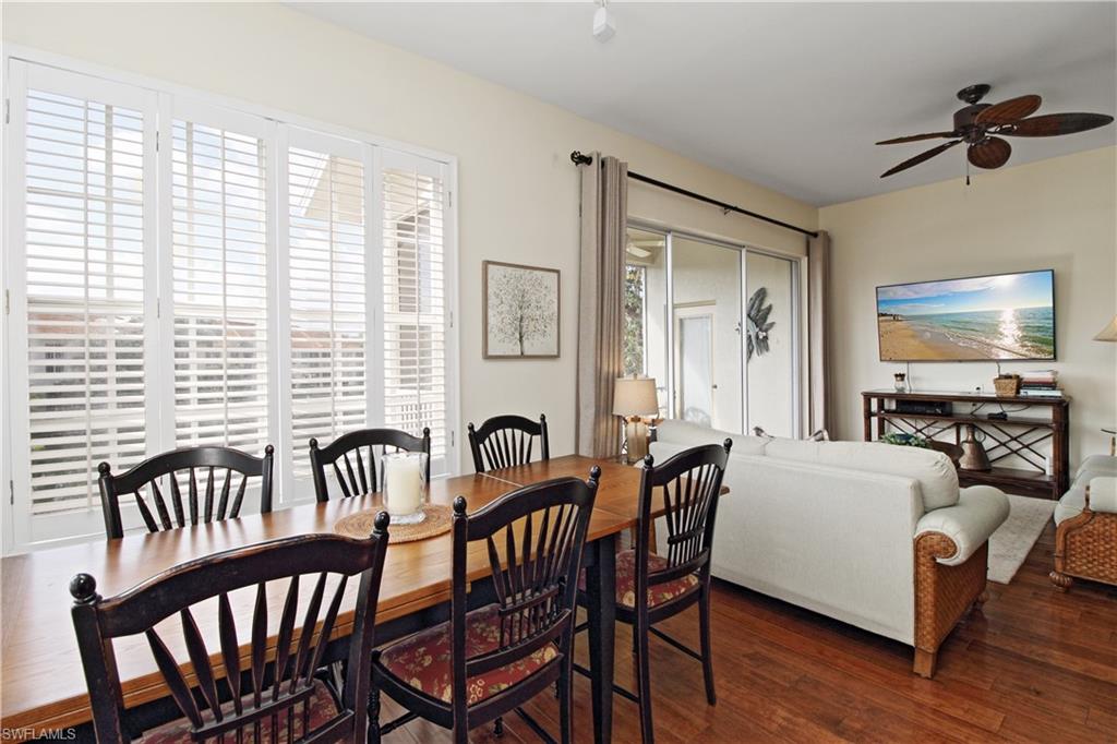 970 Egrets Run, Unit 201 Naples, FL 34108 - Photo 11 of 50 a view of a a dining room with furniture window and wooden floor