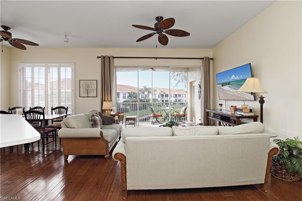 970 Egrets Run, Unit 201 Naples, FL 34108 - Photo 13 of 50 a living room with furniture and a large window