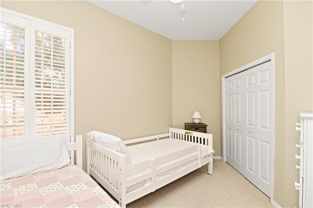 970 Egrets Run, Unit 201 Naples, FL 34108 - Photo 21 of 50 a bedroom with a bed and a window