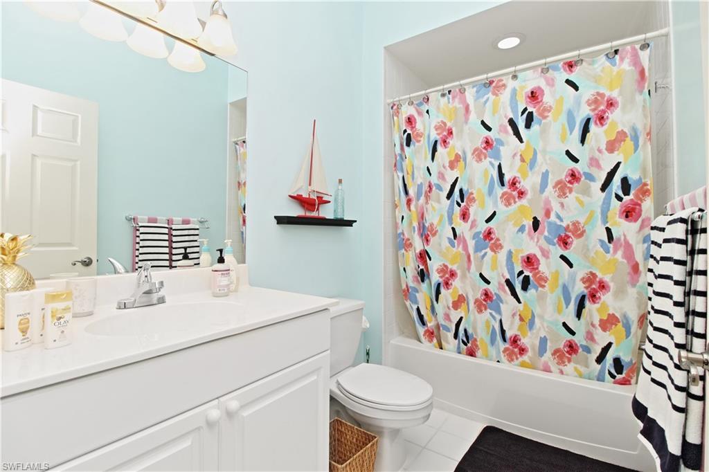 970 Egrets Run, Unit 201 Naples, FL 34108 - Photo 22 of 50 a bathroom with a sink toilet and shower
