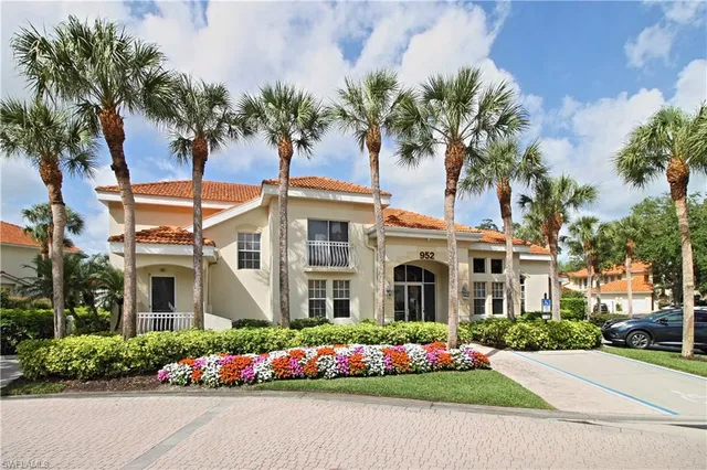 a living room with furniture a window and a chandelier