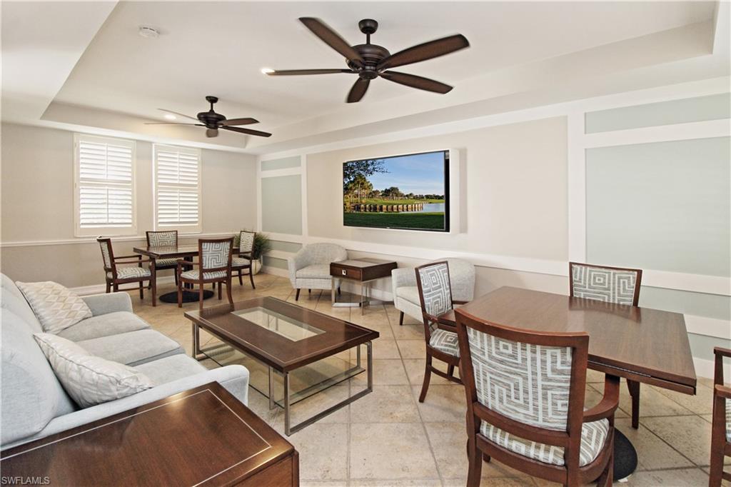 970 Egrets Run, Unit 201 Naples, FL 34108 - Photo 32 of 50 a living room with furniture a window and a chandelier