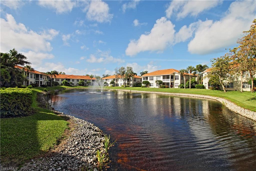 970 Egrets Run, Unit 201 Naples, FL 34108 - Photo 37 of 50 a view of a lake with houses