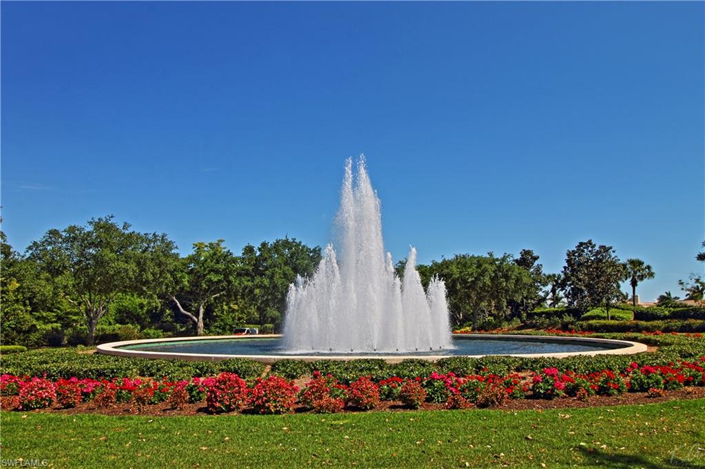 970 Egrets Run, Unit 201 Naples, FL 34108 - Photo 45 of 50 a view of a field with flowers and trees
