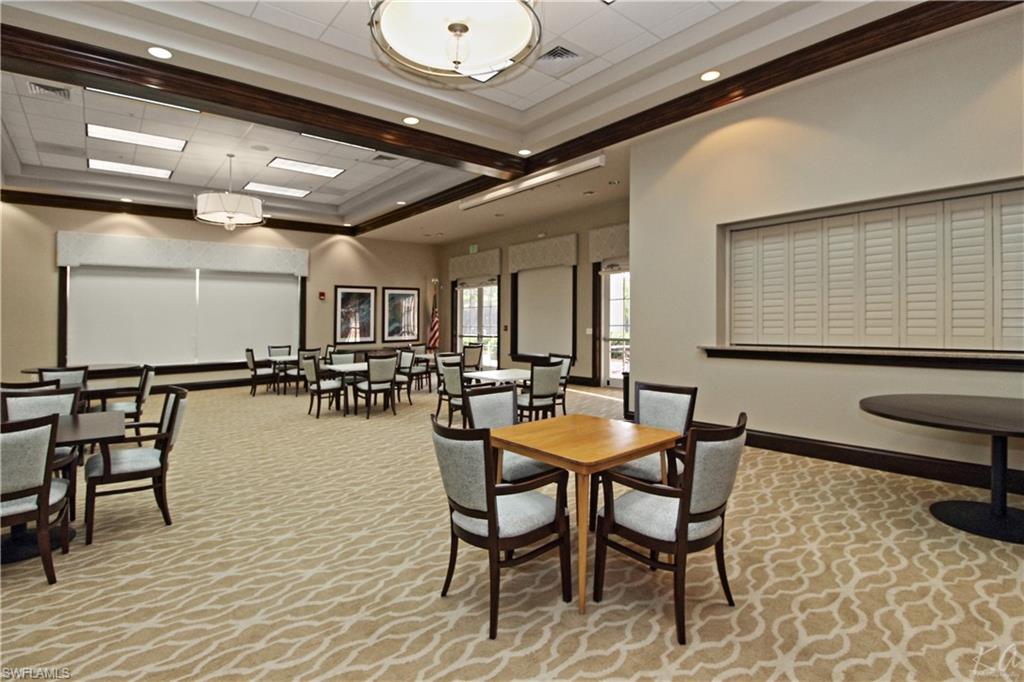 970 Egrets Run, Unit 201 Naples, FL 34108 - Photo 47 of 50 a dining hall with a table and chairs