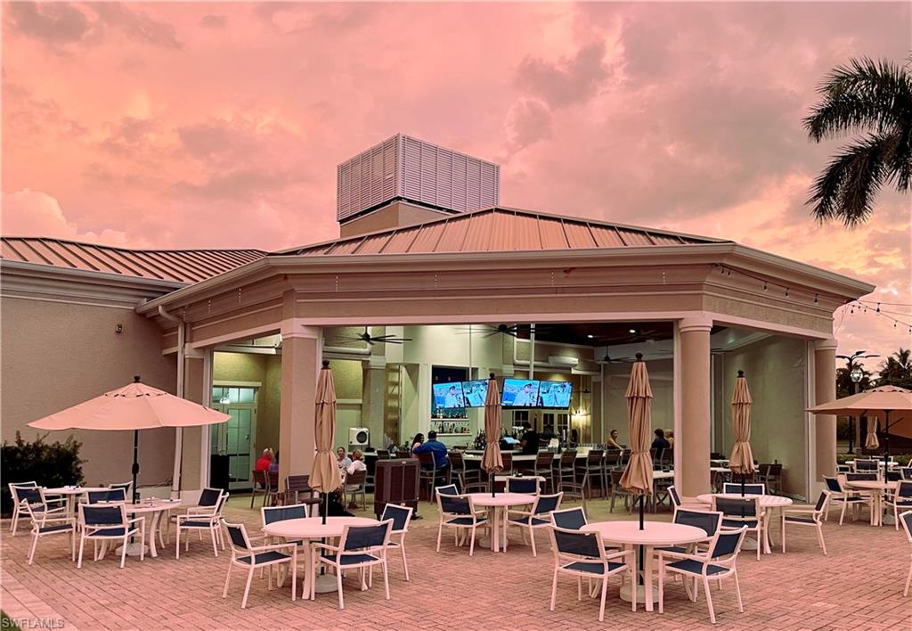 970 Egrets Run, Unit 201 Naples, FL 34108 - Photo 50 of 50 a group of lawn chairs under an umbrella