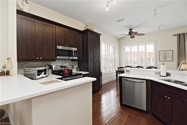 a kitchen with sink a microwave and cabinets