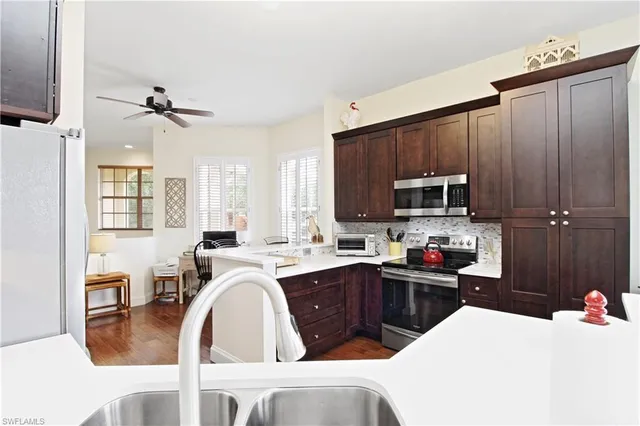a kitchen with a sink appliances and cabinets