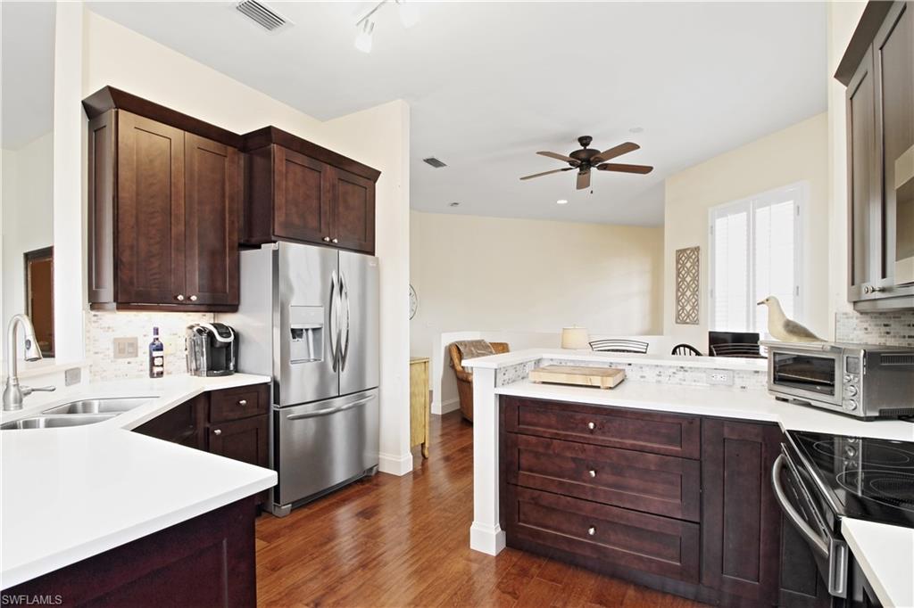 970 Egrets Run, Unit 201 Naples, FL 34108 - Photo 9 of 50 a kitchen with a sink appliances and cabinets