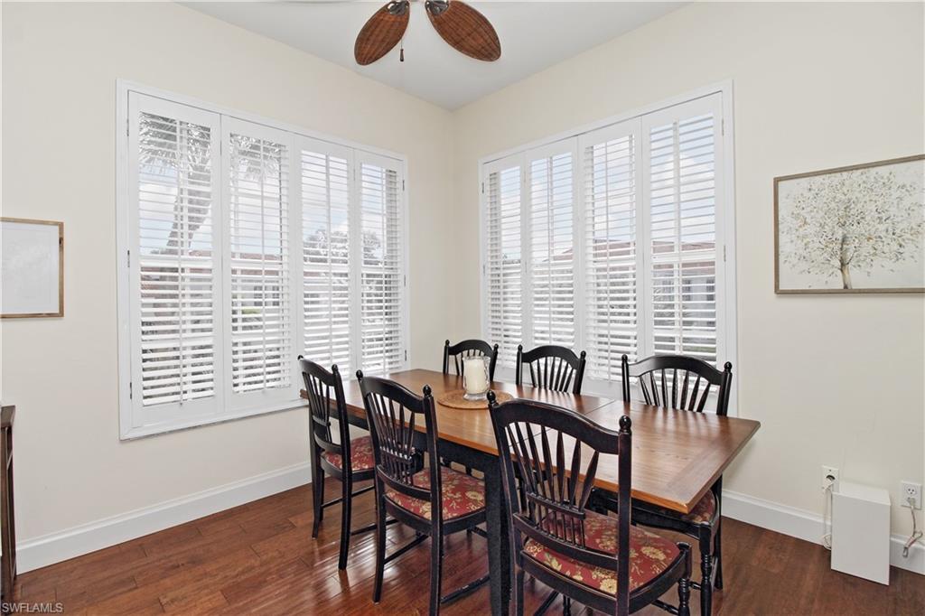 970 Egrets Run, Unit 201 Naples, FL 34108 - Photo 10 of 50 a view of a dining room with furniture window and wooden floor