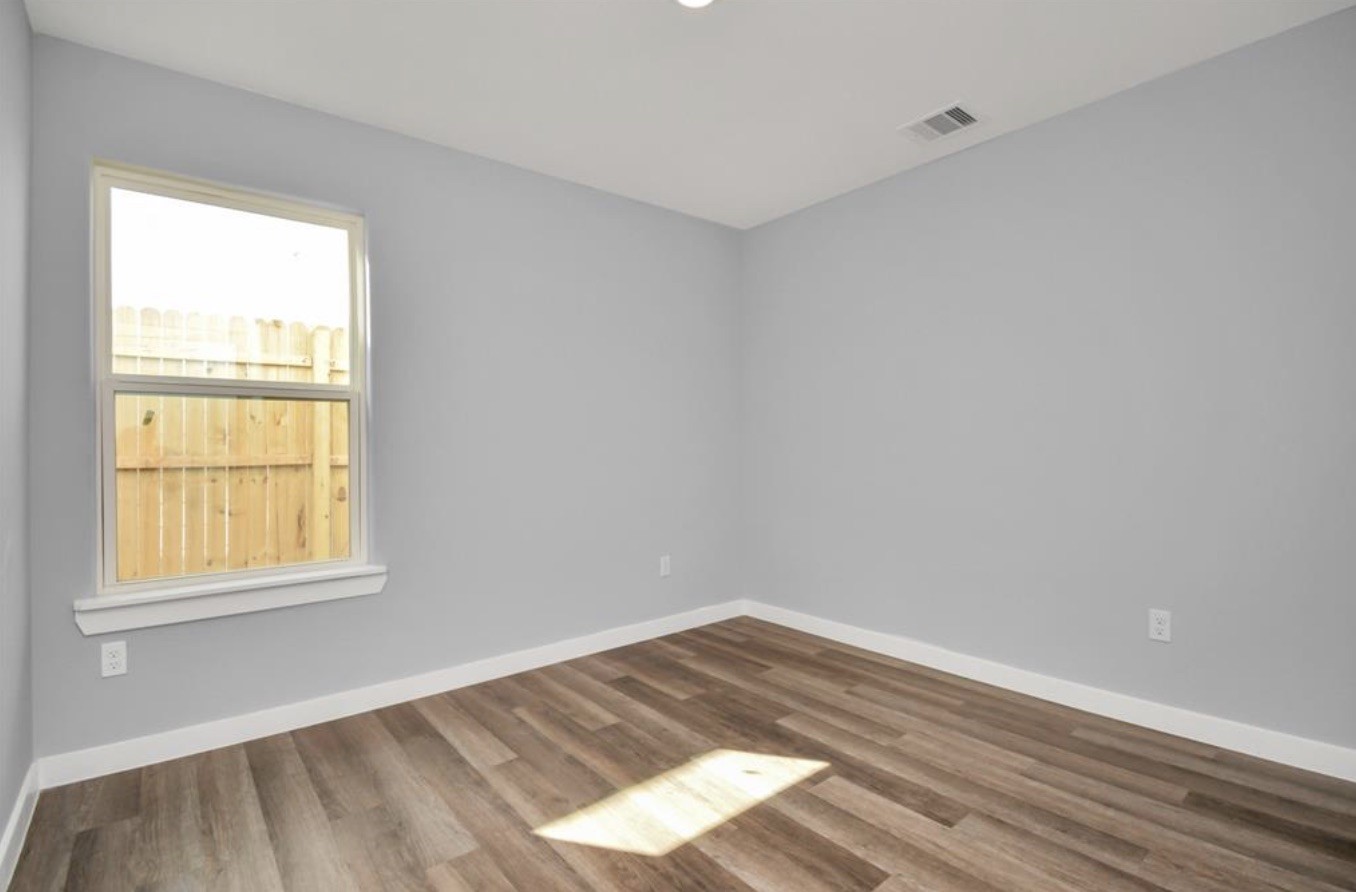 5709 Breland Street, Unit A Houston, TX 77016 - Photo 11 of 26 an empty room with a window