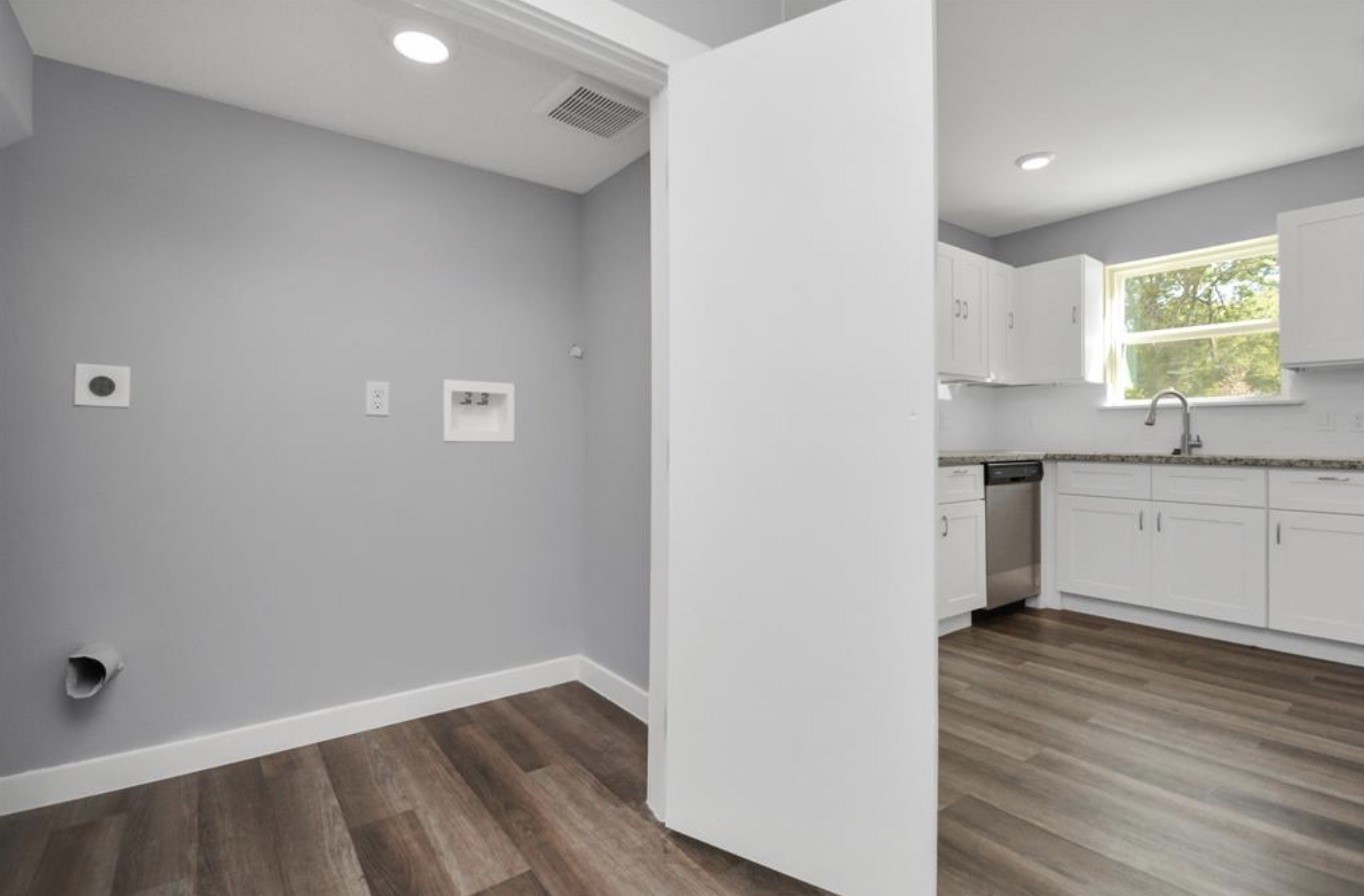 5709 Breland Street, Unit A Houston, TX 77016 - Photo 14 of 26 a view of a kitchen cabinets a sink and wooden floor
