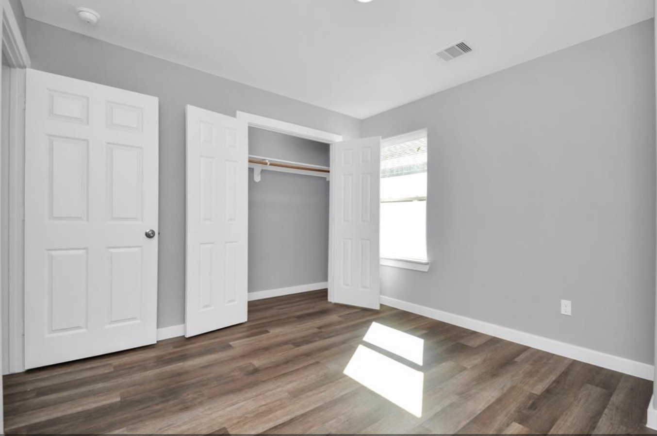 5709 Breland Street, Unit A Houston, TX 77016 - Photo 20 of 26 a view of empty room with wooden floor and fan