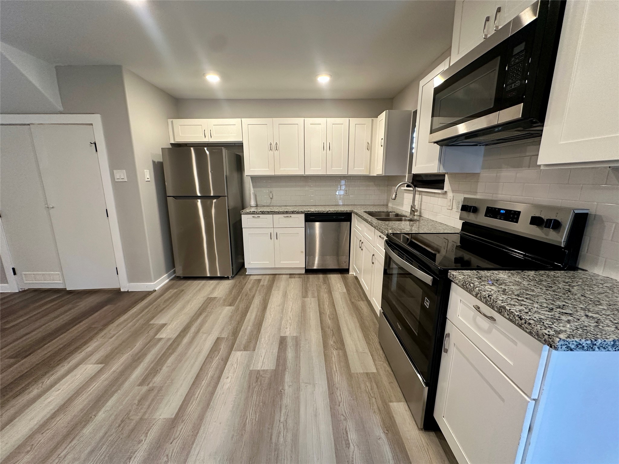 5709 Breland Street, Unit A Houston, TX 77016 - Photo 3 of 26 a kitchen with a refrigerator a sink and wooden cabinets