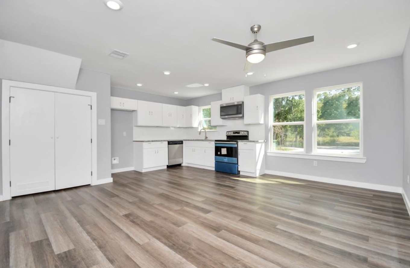 5709 Breland Street, Unit A Houston, TX 77016 - Photo 6 of 26 a view of kitchen with granite countertop cabinets and wooden floor