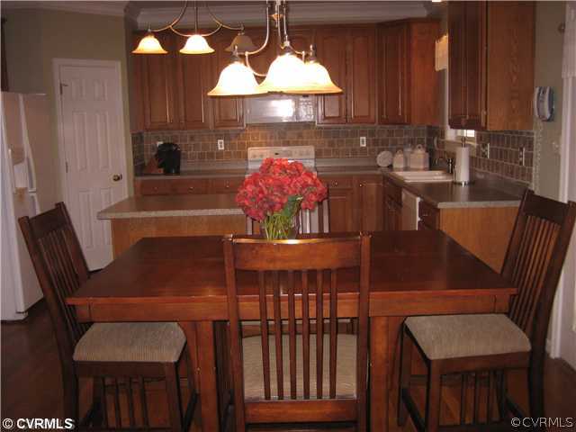 1307 Goswick Ridge Road Midlothian, VA 23114 - Photo 4 of 12 a view of a dining room with furniture and chandelier