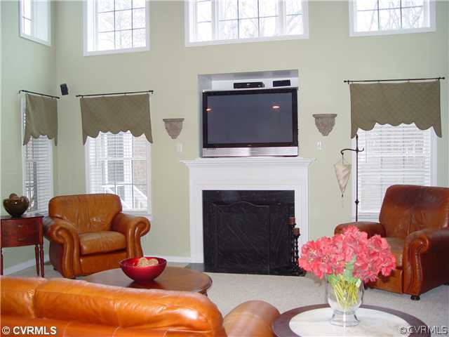 1307 Goswick Ridge Road Midlothian, VA 23114 - Photo 5 of 12 a living room with furniture a flat screen tv and a fireplace