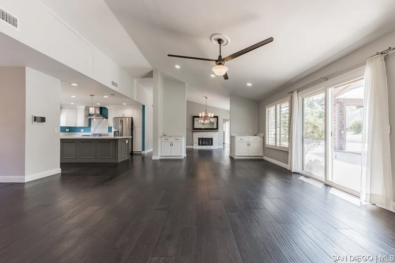 14001 Painted Desert Road Poway, CA 92064 - Photo 7 of 40 a view of a big room with wooden floor and a kitchen