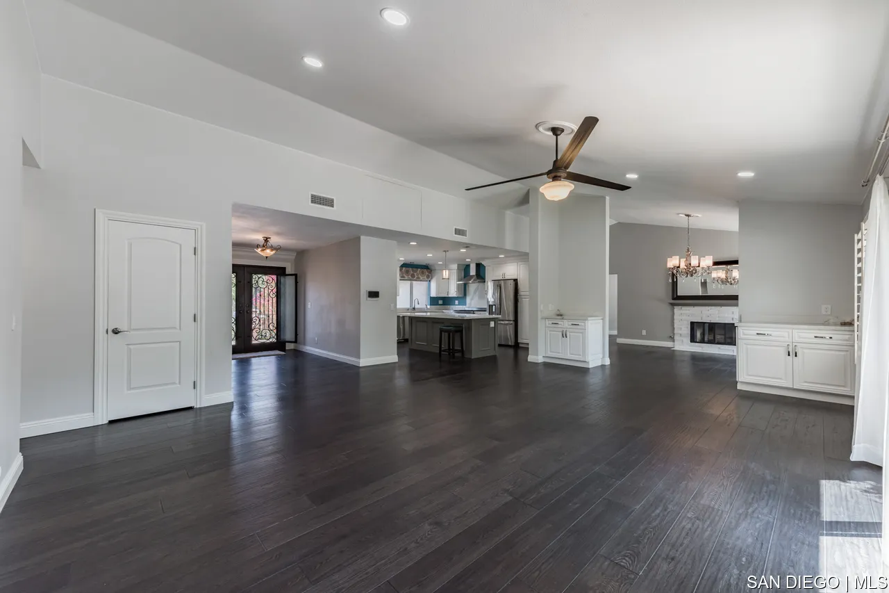 14001 Painted Desert Road Poway, CA 92064 - Photo 8 of 40 a view of an empty room with wooden floor and a ceiling fan