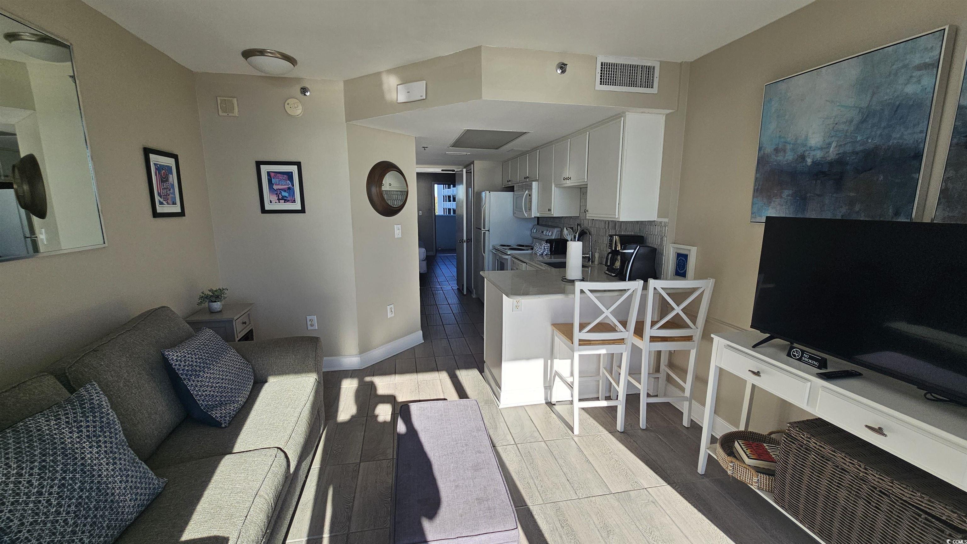 161 Seawatch Drive, Unit 610 Myrtle Beach, SC 29572 - Photo 11 of 35 Living area with baseboards