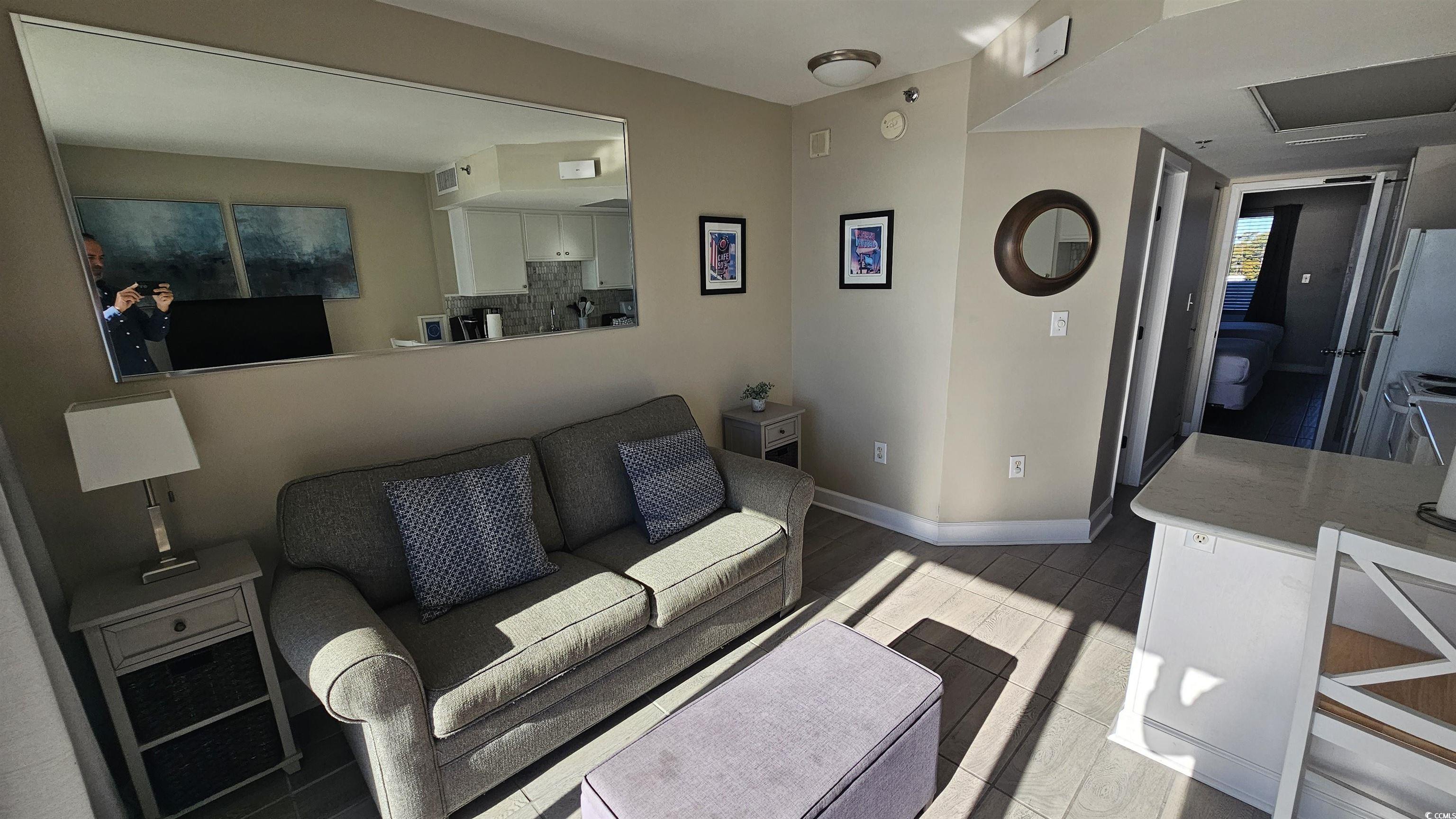 161 Seawatch Drive, Unit 610 Myrtle Beach, SC 29572 - Photo 13 of 35 Living room featuring light wood-type flooring and plenty of natural light