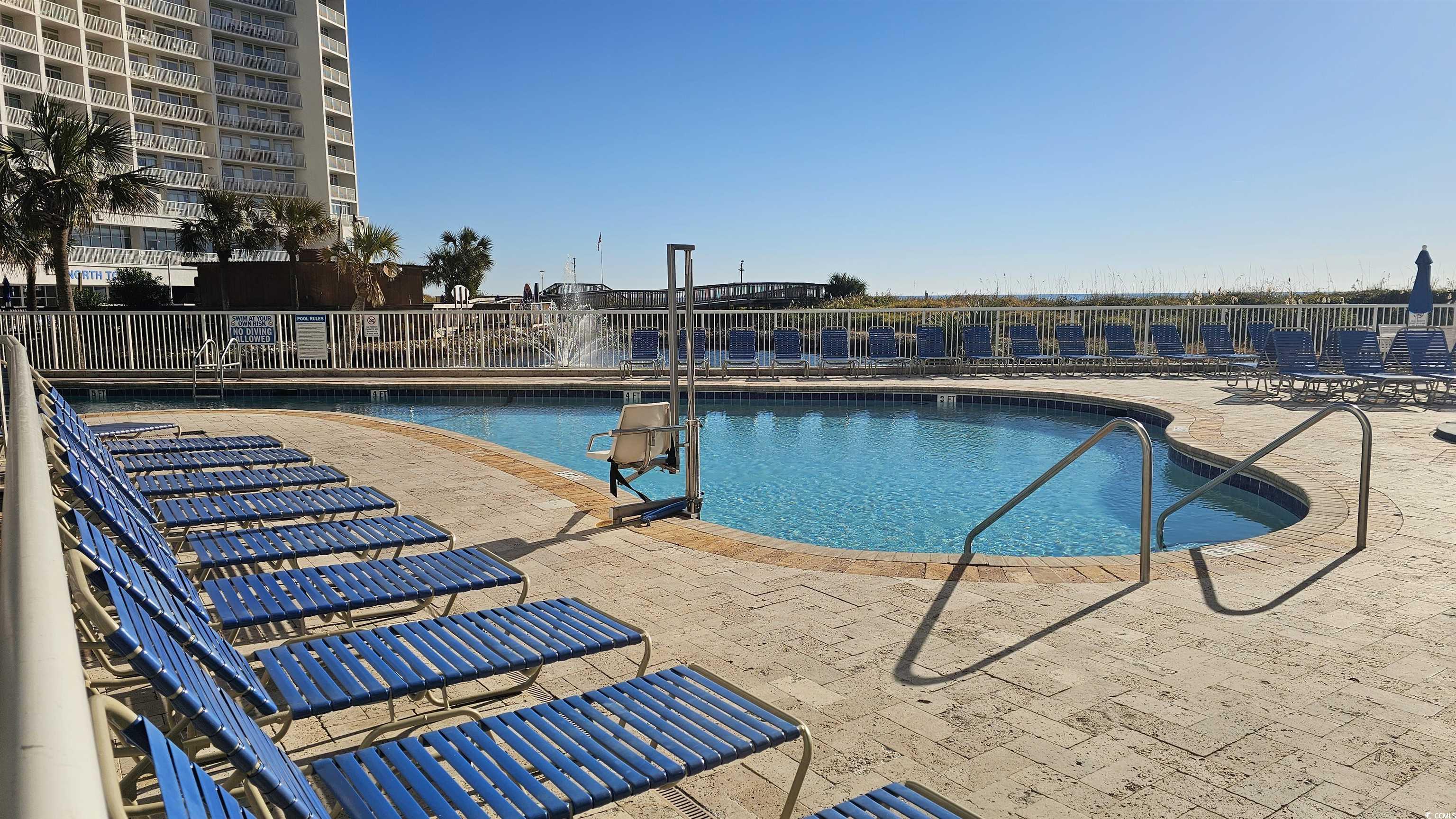 161 Seawatch Drive, Unit 610 Myrtle Beach, SC 29572 - Photo 16 of 35 Community pool featuring a patio area