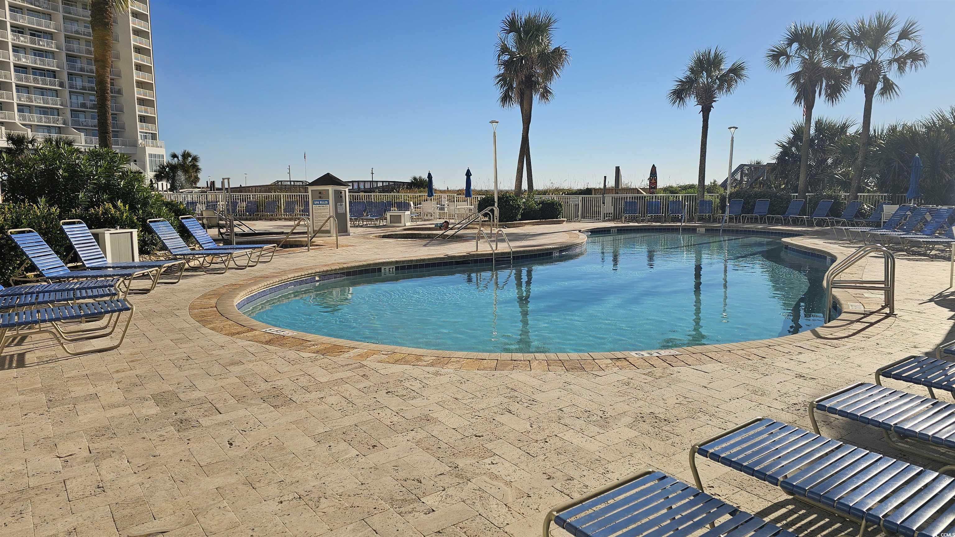 161 Seawatch Drive, Unit 610 Myrtle Beach, SC 29572 - Photo 17 of 35 Community pool featuring a patio area