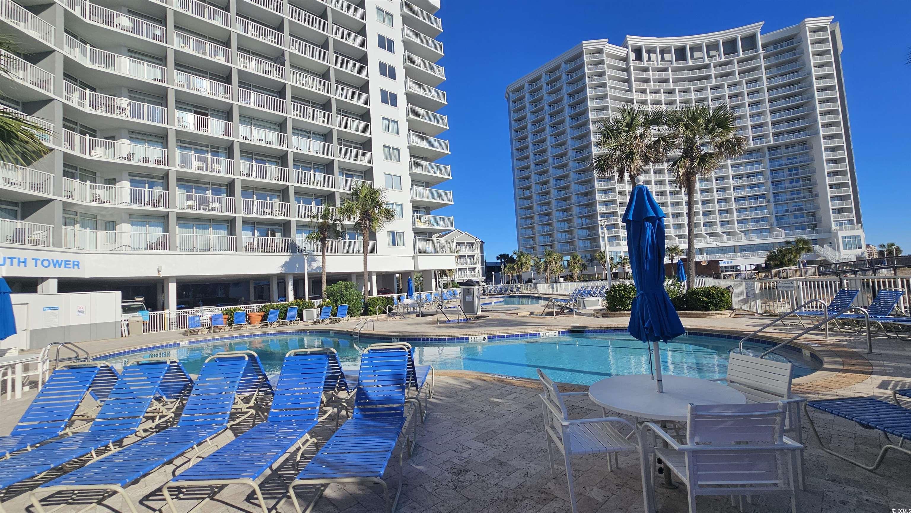 161 Seawatch Drive, Unit 610 Myrtle Beach, SC 29572 - Photo 19 of 35 Community pool featuring a patio area