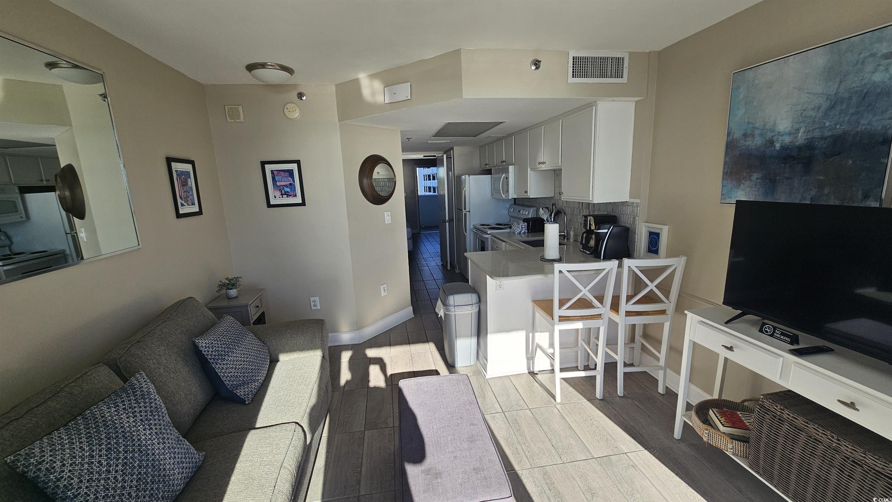 161 Seawatch Drive, Unit 610 Myrtle Beach, SC 29572 - Photo 2 of 35 Living room with baseboards and dark wood-type flooring