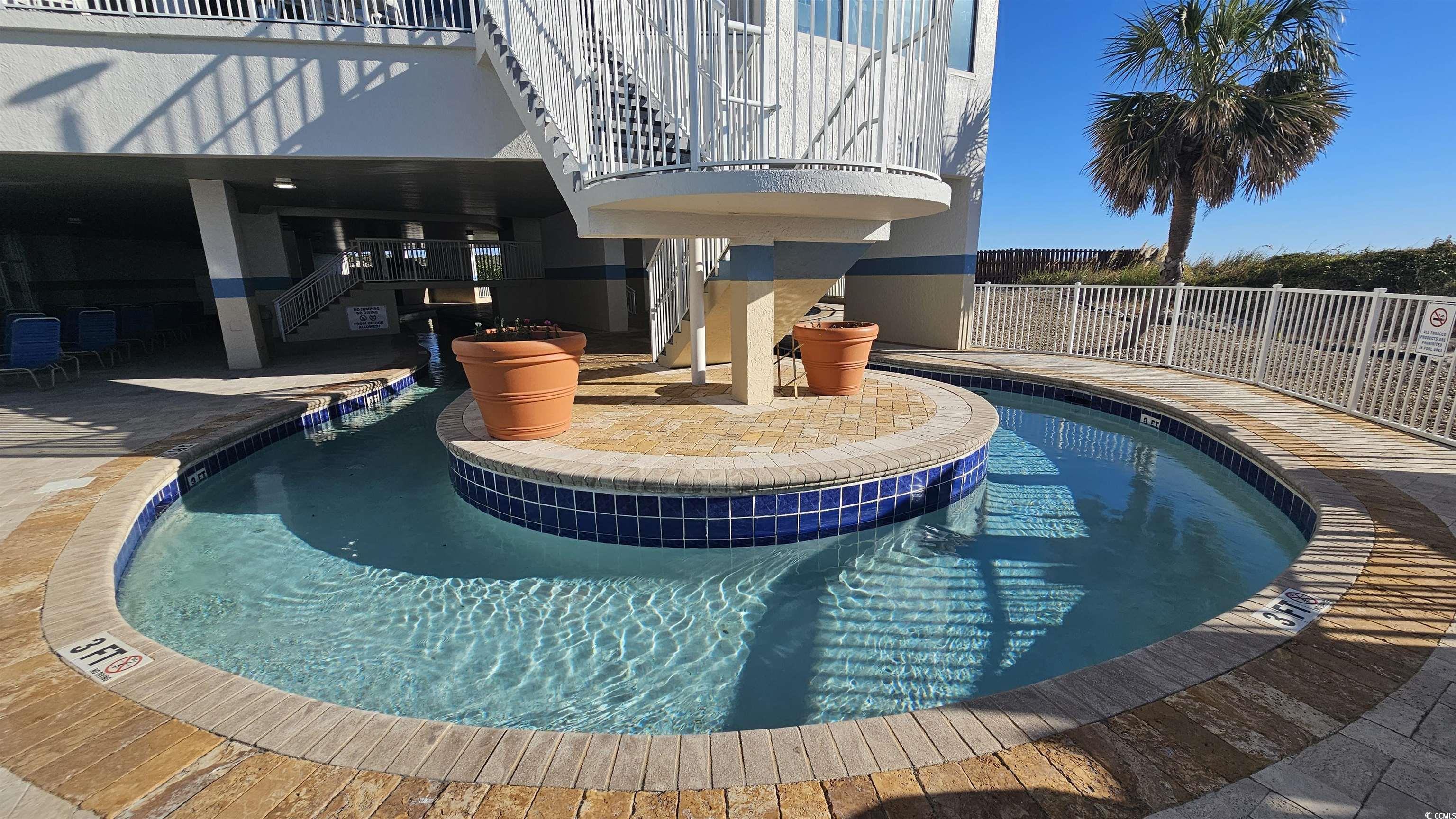 161 Seawatch Drive, Unit 610 Myrtle Beach, SC 29572 - Photo 27 of 35 Community pool with stairs and a patio area