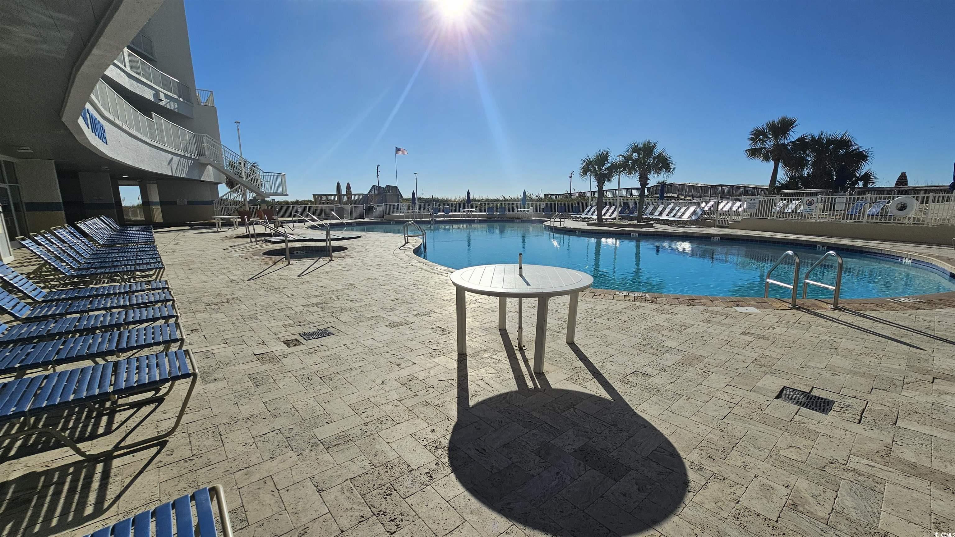 161 Seawatch Drive, Unit 610 Myrtle Beach, SC 29572 - Photo 29 of 35 Community pool featuring a patio