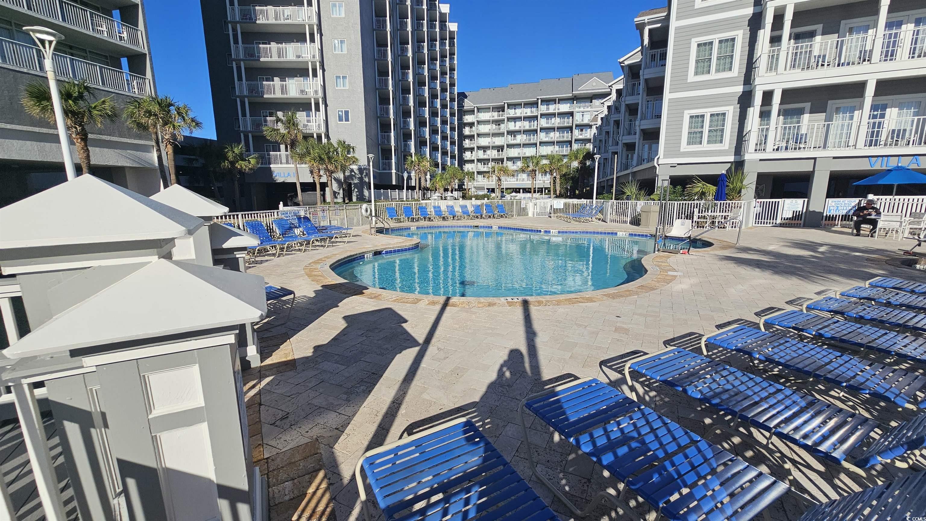 161 Seawatch Drive, Unit 610 Myrtle Beach, SC 29572 - Photo 30 of 35 Community pool with a patio area