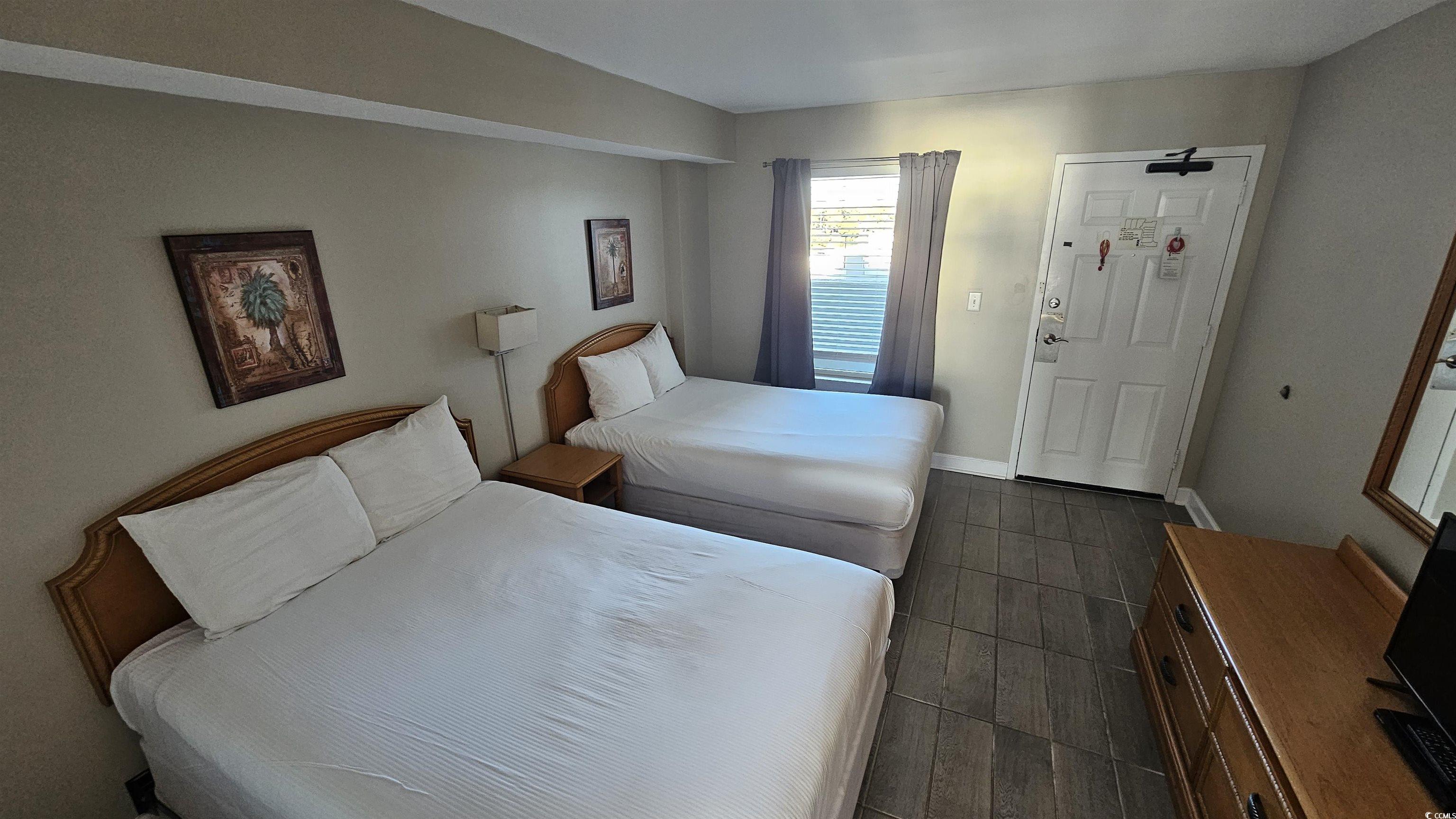 161 Seawatch Drive, Unit 610 Myrtle Beach, SC 29572 - Photo 4 of 35 Bedroom featuring dark wood-style flooring and baseboards