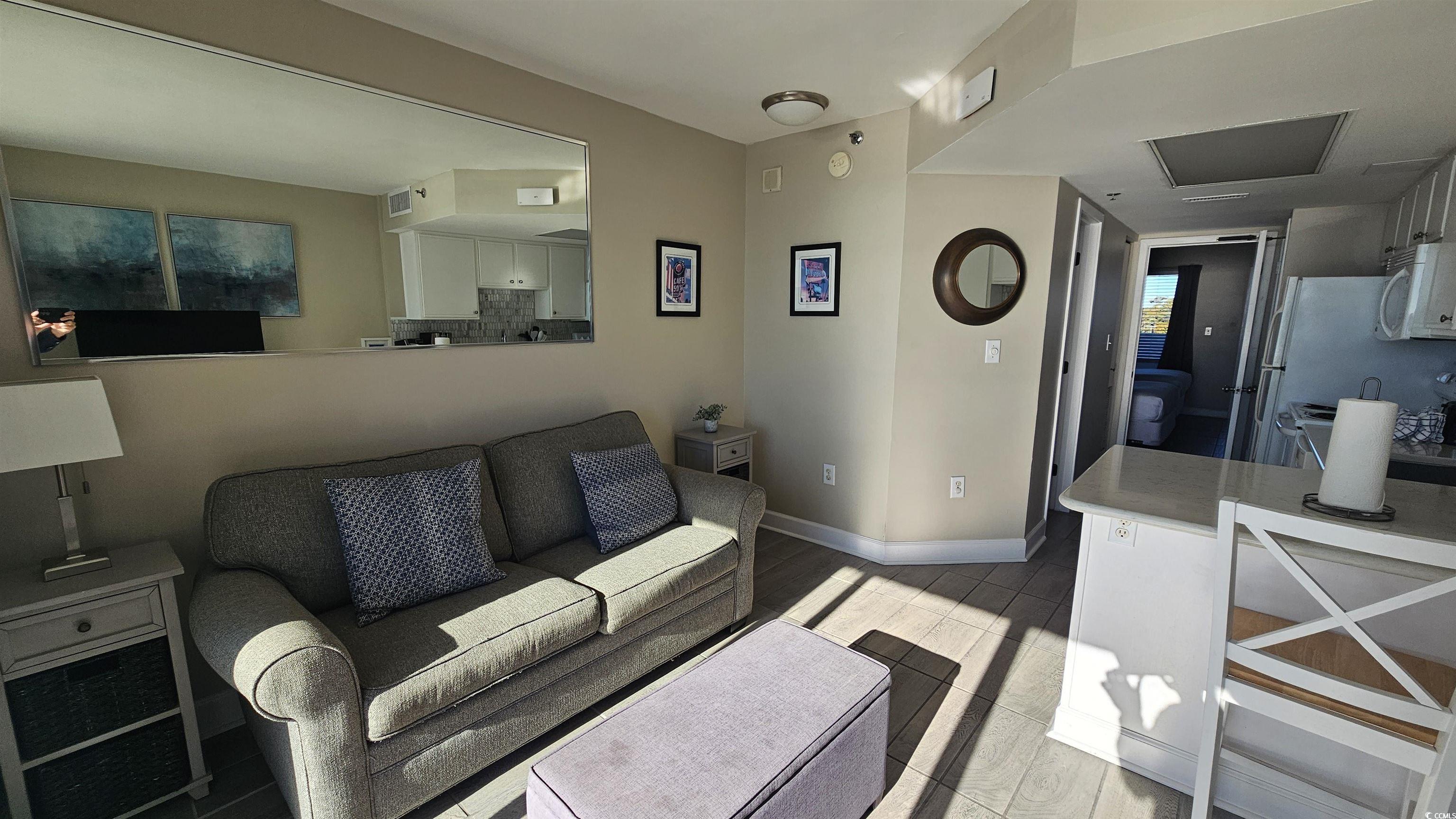 161 Seawatch Drive, Unit 610 Myrtle Beach, SC 29572 - Photo 7 of 35 Living area featuring baseboards and light wood-style flooring