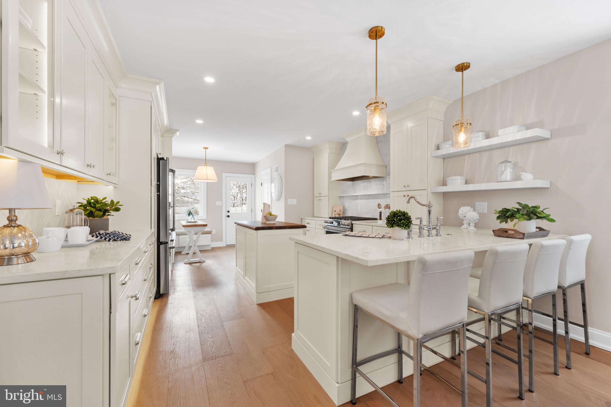 466 St Davids Avenue Wayne, PA 19087 - Photo 11 of 42 a kitchen with kitchen island a stove a table and chairs in it
