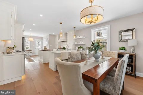 a kitchen with kitchen island a stove a table and chairs in it