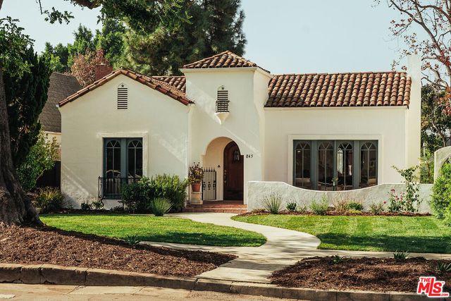 a front view of a house with garden