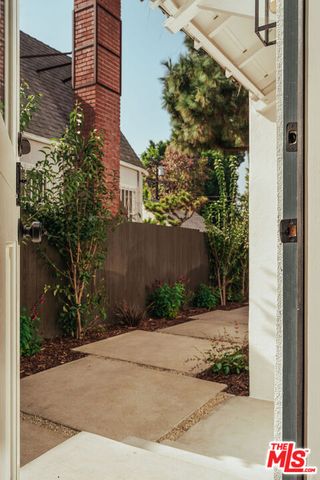 a bathroom with a granite countertop sink a mirror and shower