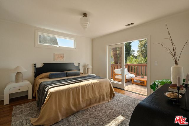 a bathroom with a potted plant and a shower in it