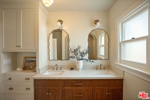 a bedroom with a bed and a view of living room