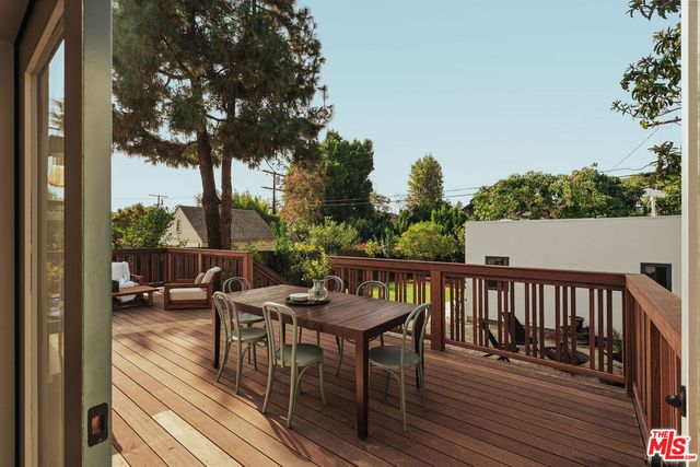 a bedroom with a bed couch and a window