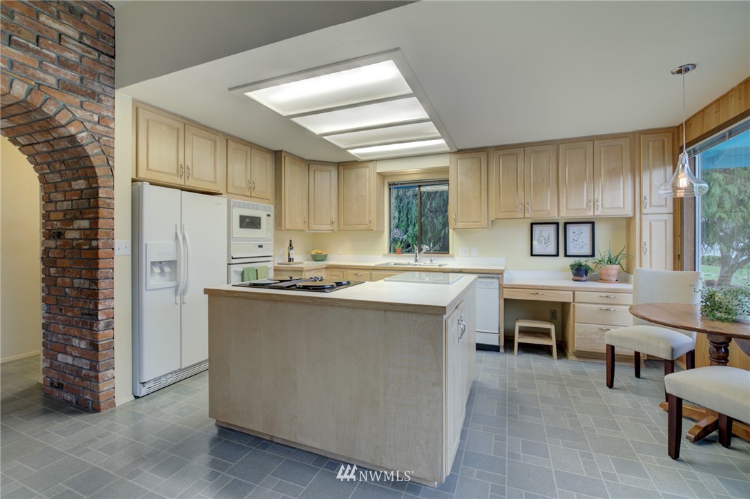 1104 Dyer Road Sultan, WA 98294 - Photo 11 of 40 a kitchen with cabinets and chairs