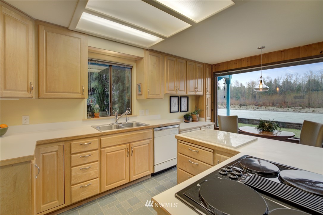 1104 Dyer Road Sultan, WA 98294 - Photo 13 of 40 a room with stainless steel appliances kitchen island granite countertop a sink and cabinets
