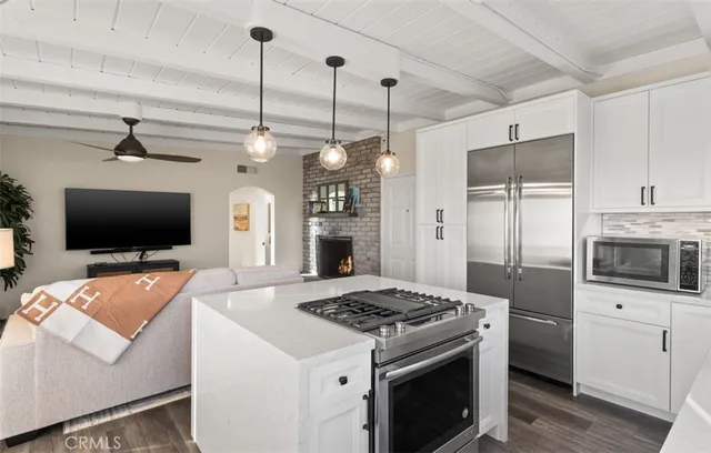 a kitchen with stainless steel appliances a stove a sink and a refrigerator