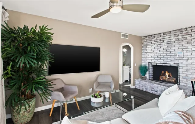 a living room with furniture potted plant and a fireplace