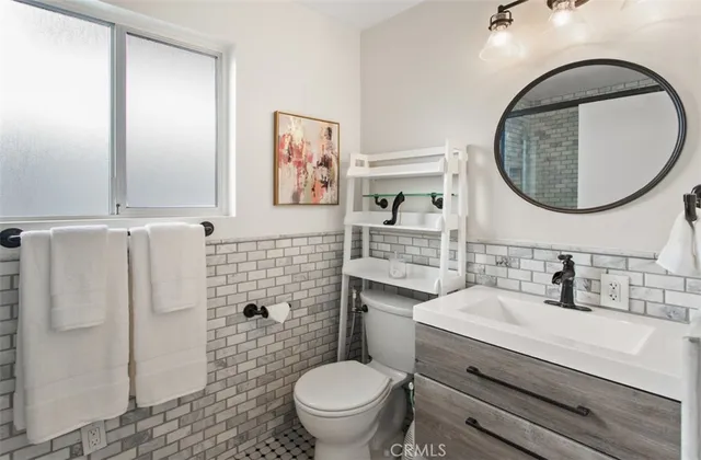 a bathroom with a toilet a sink and mirror