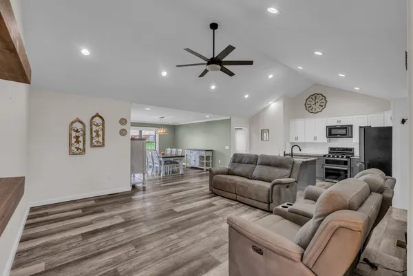 a living room with furniture and a ceiling fan